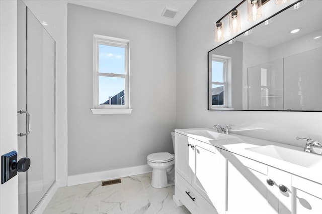 bathroom with vanity, a shower with door, and toilet