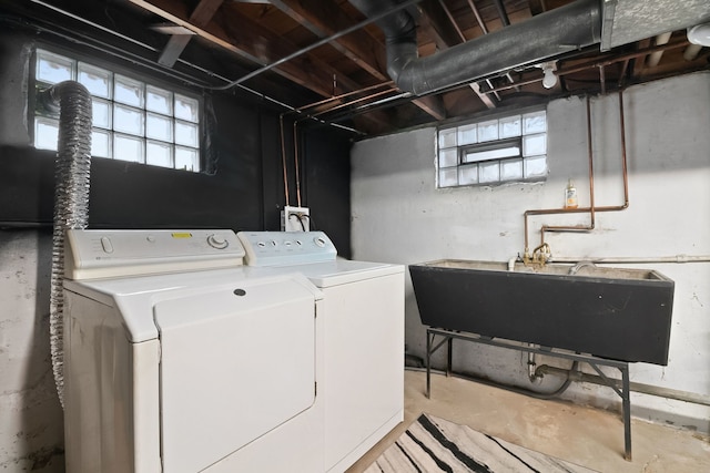 laundry area with washer and clothes dryer and sink