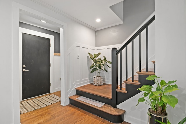 entryway featuring ornamental molding and hardwood / wood-style flooring