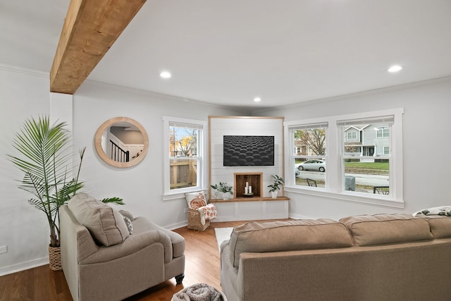 living room with beam ceiling, crown molding, and wood-type flooring