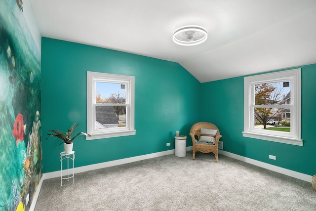 unfurnished room featuring carpet, a healthy amount of sunlight, and lofted ceiling