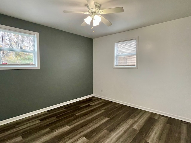 spare room with ceiling fan and dark wood-type flooring