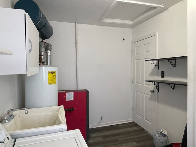 laundry area with gas water heater, dark hardwood / wood-style floors, and sink