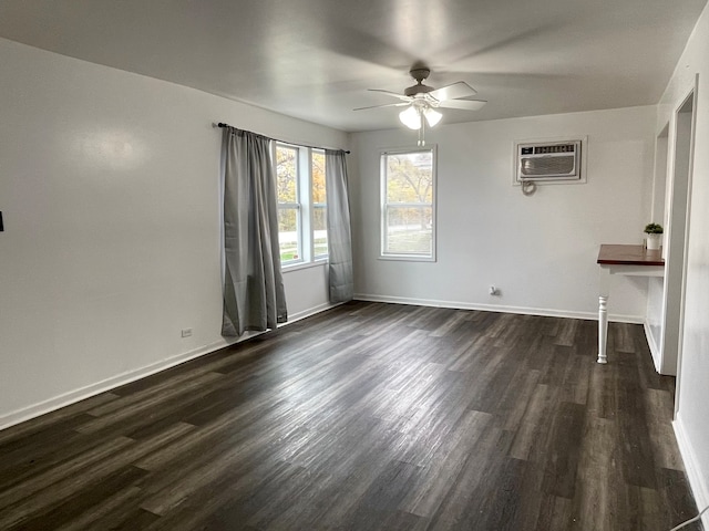 unfurnished room featuring a wall unit AC, ceiling fan, and dark hardwood / wood-style floors