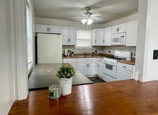 kitchen featuring decorative backsplash, white appliances, ceiling fan, sink, and white cabinets