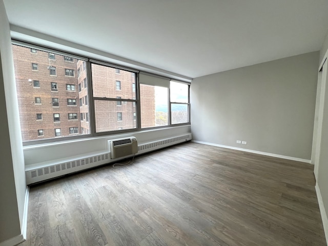 empty room featuring radiator and wood-type flooring