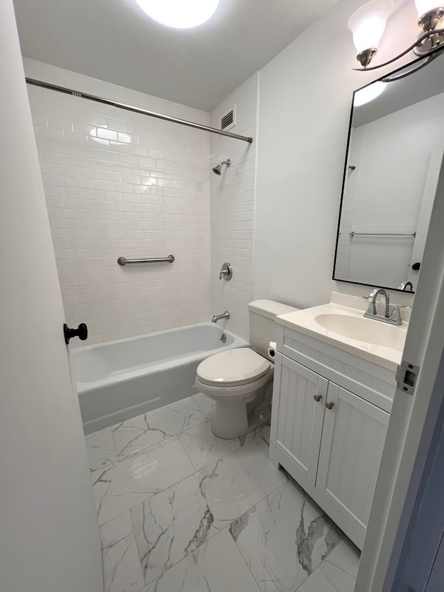 full bathroom featuring vanity, toilet, and tiled shower / bath