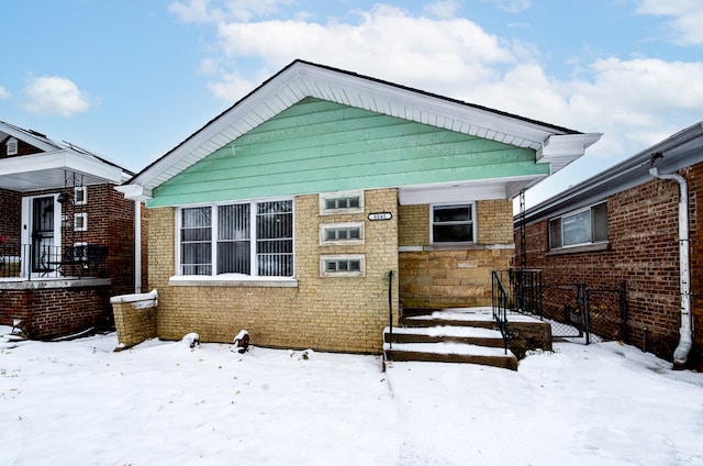 view of snow covered rear of property