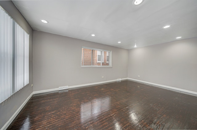 spare room with dark hardwood / wood-style floors