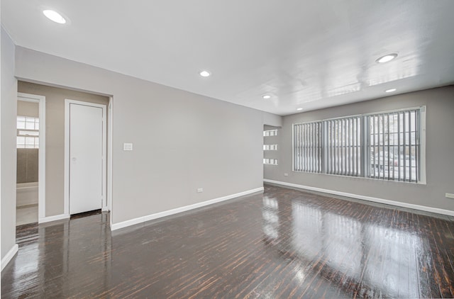 empty room with dark hardwood / wood-style flooring