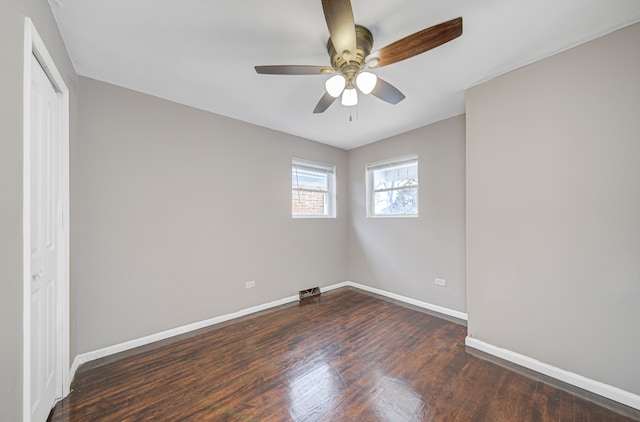 unfurnished room with ceiling fan and dark wood-type flooring