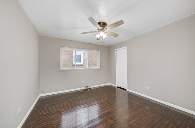 spare room featuring dark hardwood / wood-style floors and ceiling fan