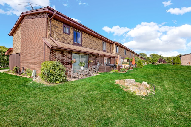 back of property with a lawn and a patio area