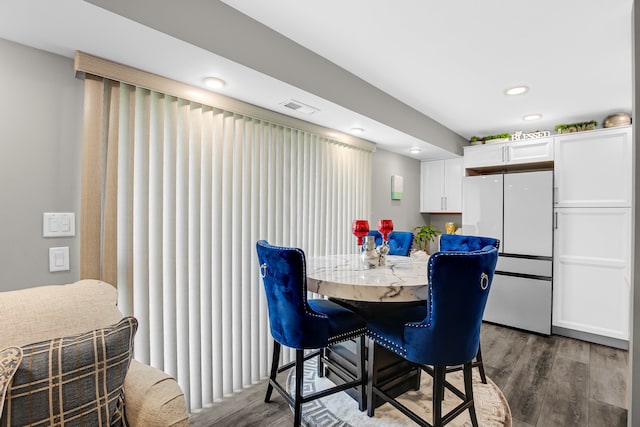 dining area with dark hardwood / wood-style floors