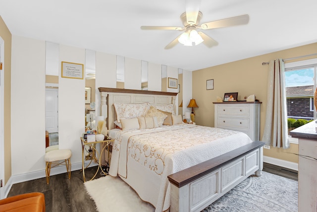 bedroom with dark hardwood / wood-style flooring and ceiling fan