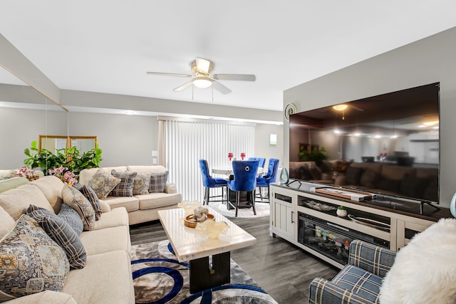 living room with ceiling fan and dark wood-type flooring