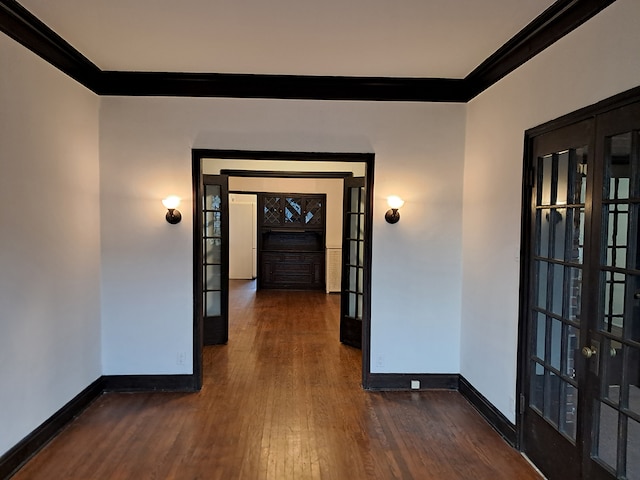 hallway with dark hardwood / wood-style flooring, french doors, and ornamental molding