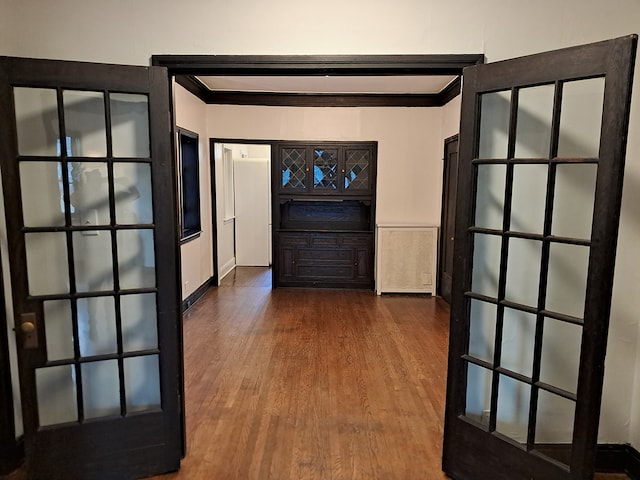 hallway with ornamental molding and hardwood / wood-style flooring