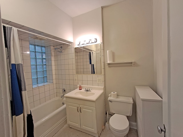 full bathroom featuring toilet, vanity, tile patterned floors, and shower / bathtub combination with curtain