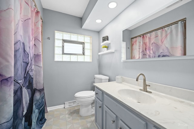 bathroom featuring tile patterned flooring, vanity, a shower with shower curtain, and toilet