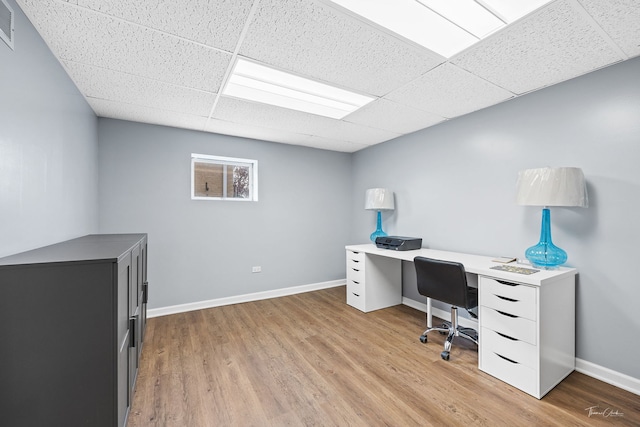 office with a paneled ceiling and light wood-type flooring