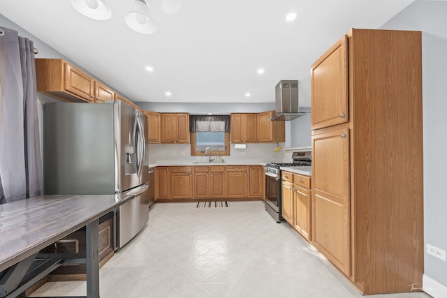 kitchen with wall chimney exhaust hood, sink, appliances with stainless steel finishes, and tasteful backsplash