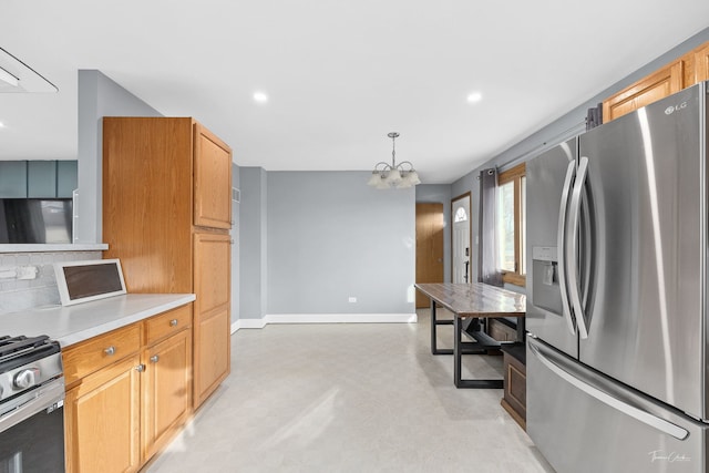 kitchen featuring pendant lighting, a notable chandelier, backsplash, and appliances with stainless steel finishes