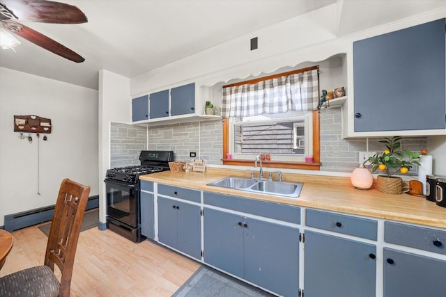 3820 W 117th St, Alsip, IL 60803 - kitchen featuring black gas range, blue cabinets, decorative backsplash, a ceiling fan, and light wood finished floors