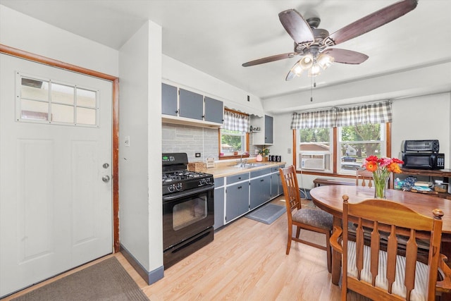3820 W 117th St, Alsip, IL 60803 - kitchen featuring black gas range oven, gray cabinets, light wood-style flooring, light countertops, and a ceiling fan