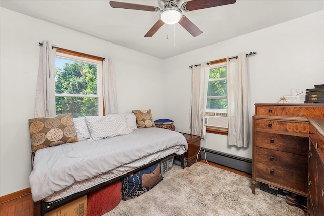 3820 W 117th St, Alsip, IL 60803 - bedroom with a baseboard radiator, cooling unit, wood finished floors, and a ceiling fan