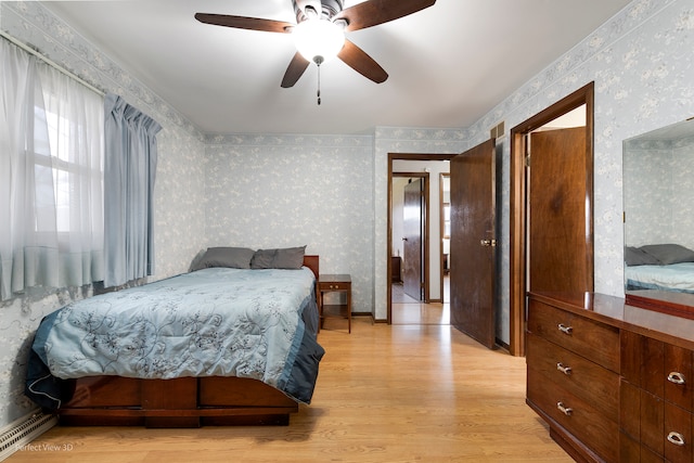 bedroom with ceiling fan and light hardwood / wood-style flooring