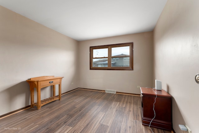 empty room with dark wood-type flooring