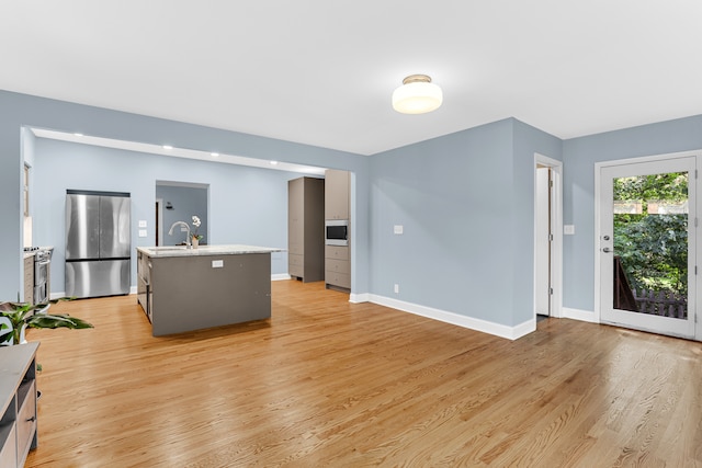 living room featuring light wood-type flooring and sink