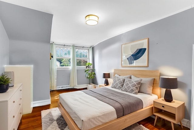 bedroom with dark hardwood / wood-style flooring