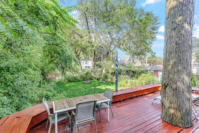 wooden terrace with a lawn