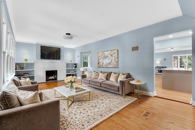 living room featuring hardwood / wood-style flooring and vaulted ceiling