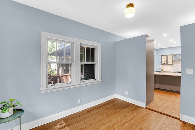 empty room featuring sink and light wood-type flooring