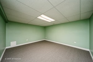 unfurnished room with carpet and a paneled ceiling