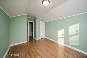 additional living space featuring hardwood / wood-style floors and lofted ceiling