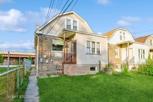 rear view of property with a lawn