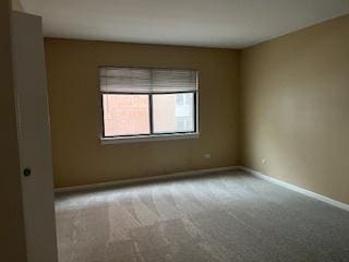 empty room featuring light colored carpet