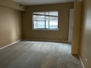 unfurnished room featuring light colored carpet