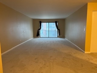 spare room featuring carpet floors