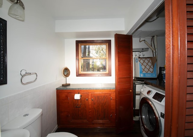 washroom featuring washer / dryer and tile walls