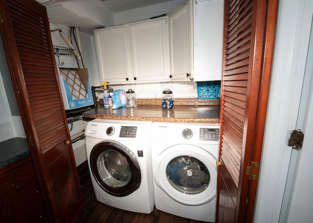 clothes washing area with cabinets, washing machine and dryer, and dark wood-type flooring