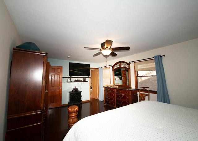 bedroom with ceiling fan and dark hardwood / wood-style floors