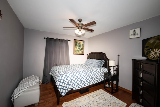 bedroom featuring dark hardwood / wood-style flooring and ceiling fan