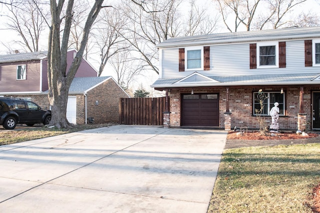 view of property featuring covered porch and a garage