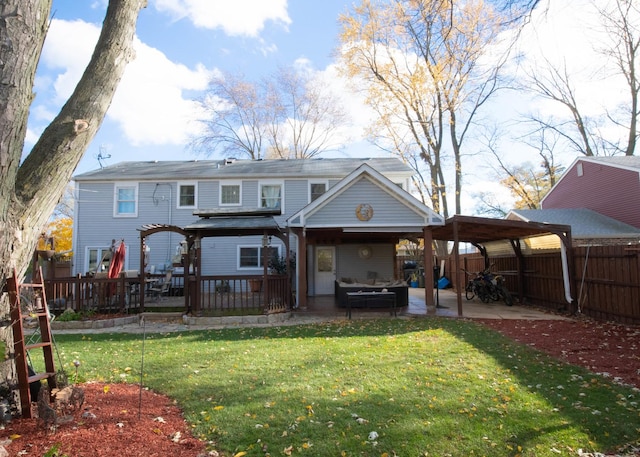 rear view of property featuring a lawn, a patio area, and a pergola