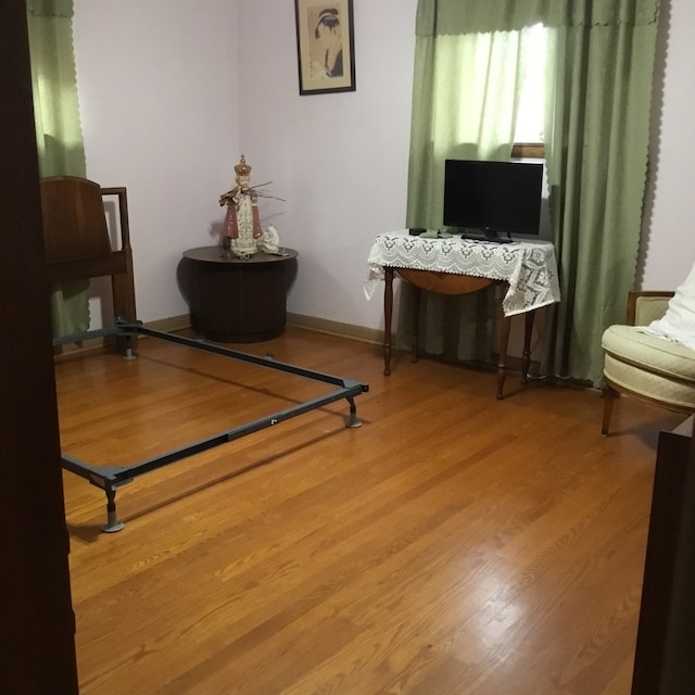 living area with hardwood / wood-style flooring